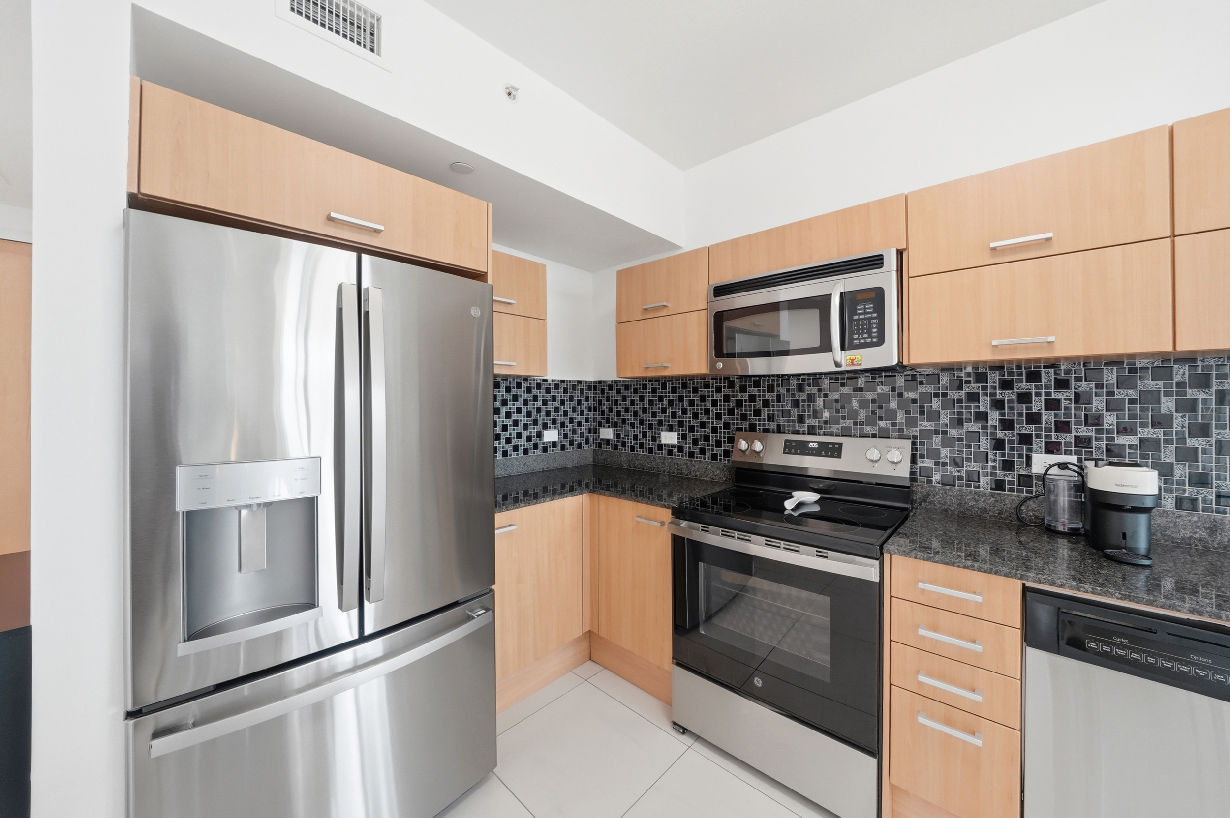 Kitchen detail with dark granite countertops — Wind Condo Miami